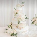 four tier half masked roses wedding cake