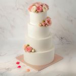 four tiers masked roses wedding cake