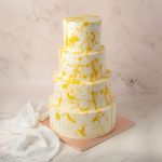 four tiers masked classic wedding cake